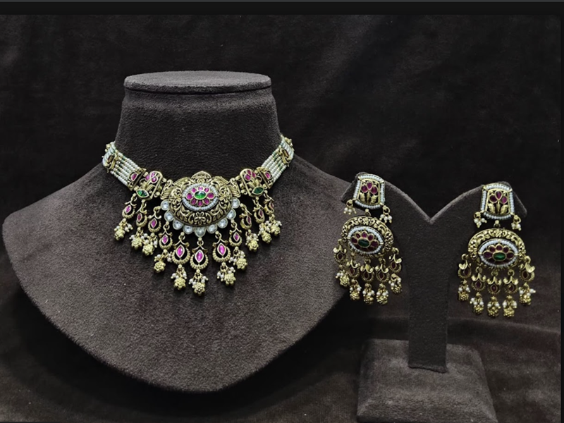 Traditional necklace and matching earrings with intricate stone detailing